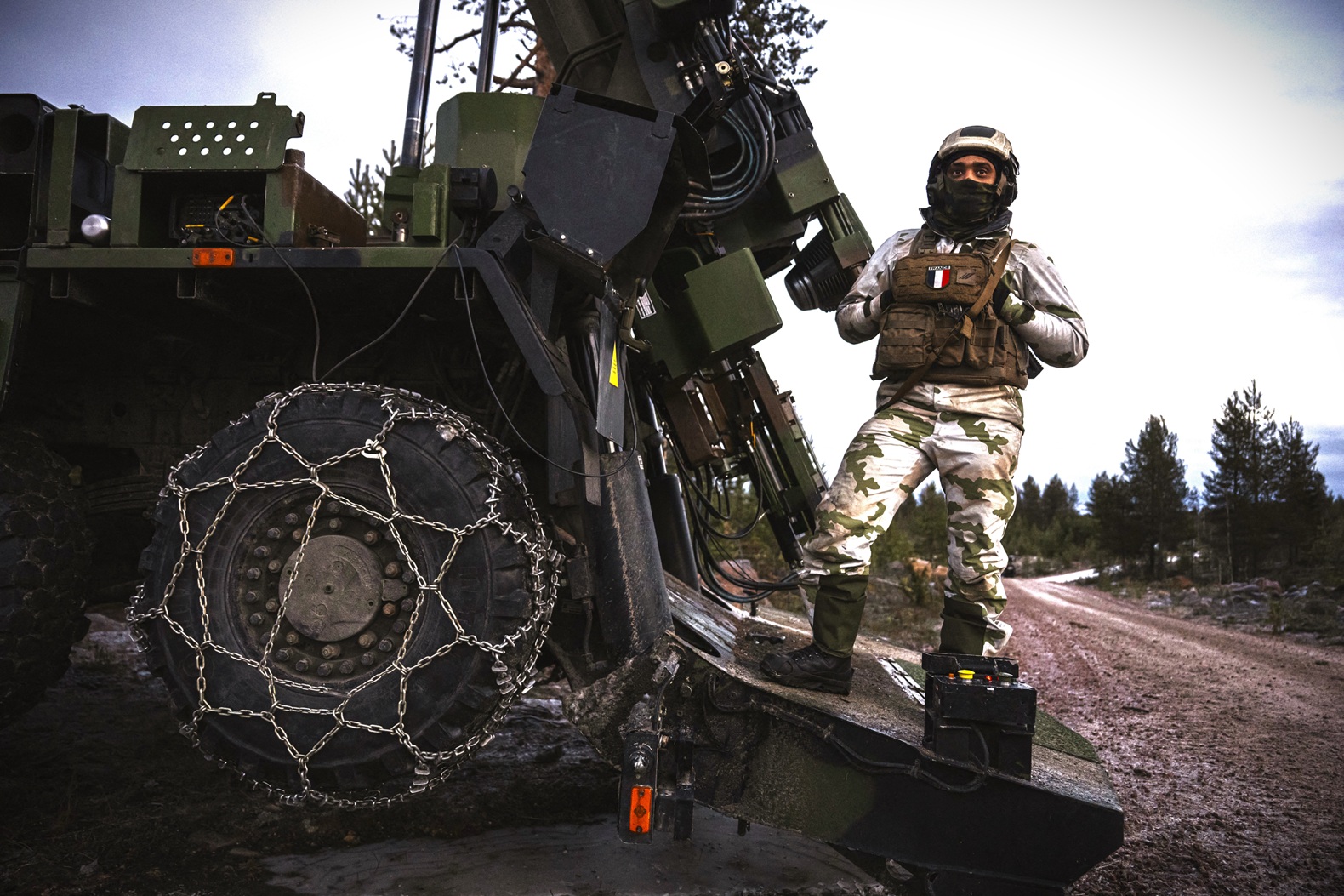 Specialised military vehicle fitted with RUD snow chains for maximum traction and mobility in the demanding terrain encountered in the defence sector.